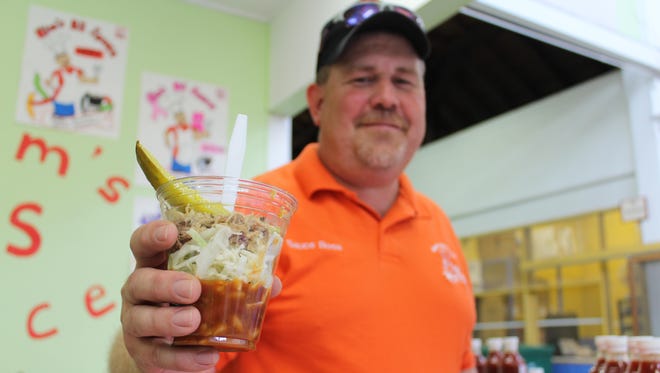 Kim Lemke, owner of Kim’s BS Sauce, holds his pulled pork sundae.
