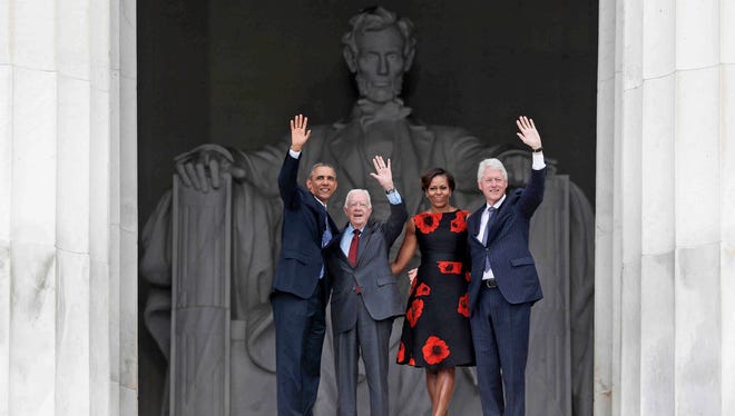 President Obama, first lady Michelle Obama, former president Jimmy Carter and former president Bill Clinton wave as they leave the 50th Anniversary of the March on Washington Wednesday at the Lincoln Memorial.
