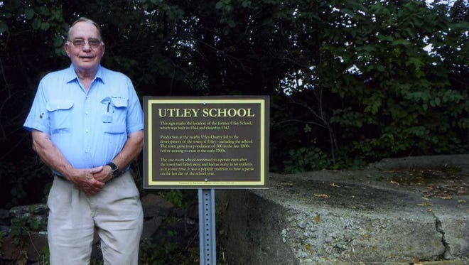 Ray Jahns, aka “Mr. Utley” stands next to a new sign that marks the location of the former Utley School in Utley, near Fairwater.