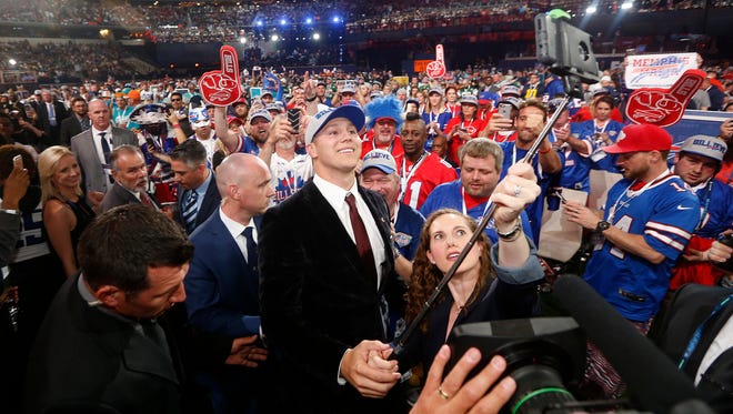 Wyoming's Josh Allen, center, takes a selfie of himself with Buffalo Bills fans after being selected by the team during the first round of the NFL football draft, Thursday, April 26, 2018, in Arlington, Texas. (AP Photo/Michael Ainsworth)