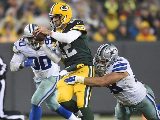 Green Bay Packers quarterback Aaron Rodgers (12) scrambles