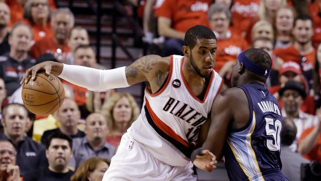 Portland Trail Blazers forward LaMarcus Aldridge, left, works the ball in against Memphis Grizzlies forward Zach Randolph during the first half of Game 4 of a first-round NBA basketball playoff series in Portland, Ore. A person with knowledge of the negotiations says LaMarcus Aldridge and the Miami Heat have spoken about his future plans, and that a formal conversation is scheduled for Thursday night, July 2, 2015.