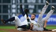 The Astros' George Springer, left, collides with Athletics