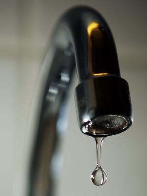 Water drops out of a tap.