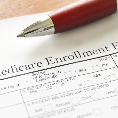 Pen resting on Medicare enrollment form