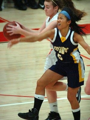 Fontbonne Josephine Wong tries to take the ball from Milton's Katherine Phelan.  Fontbonne played at Milton in high school girls basketball Thursday, January 6, 2011.