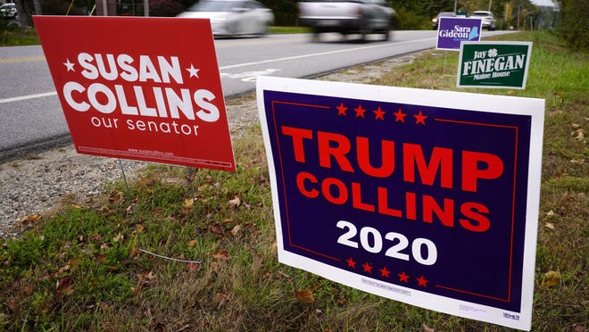 A "TRUMP COLLINS 2020" sign, right, paid for by the Maine Democratic Party, stands alongside a "Susan Collins our senator" sign, paid for by the Maine Republican Party, Wednesday, Oct. 7, 2020, in Freeport, Maine. Sen. Collins, R-Maine, is being challenged by Democrat Sara Gideon.
