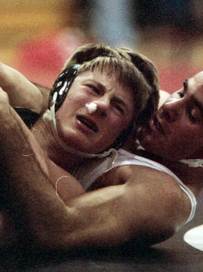 West High School wrestler Matt Brown and Halls High SchoolÕs Shawn Sayne compete in December 1995.