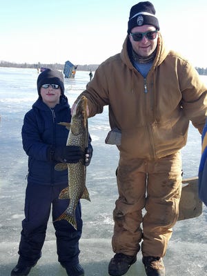 Martin Luther School third grade student Andrew Berger pulled in a 33-inch northern pike with the assistance of parent helper, Dominic Lapean, during the school’s Lutheran Boy Pioneers ice fishing outing on White Lake earlier this year.