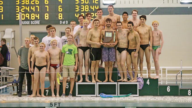 Zionsville swimmers accept the first place sectionals trophy during the during the IHSAA boys 2017 Sectional Swimming & Diving Finals, at Zionsville high School, Feb. 18, 2017. 