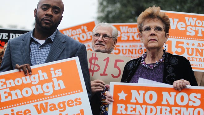 D.A. Robin/Democrat
State Rep. Alan Williams, Wakulla County Commissioner Howard Kessler and organizer Barbara DeVane hold signs at a Tuesday rally urging lawmakers to raise the minimum wage.
State Rep. Alan Williams, Wakulla County Commissioner Howard Kessler and organizer Barbara DeVane hold signs at a Tuesday rally urging lawmakers to raise the minimum wage to $15 an hour.