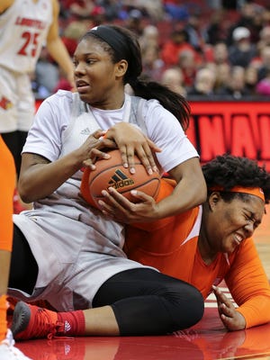 U of L’s Myisha Hines-Allen (2) grapples for a loose ball against Clemson’s Ivy Atkism (24) during their game at the Yum Center.  
Feb. 7, 2018