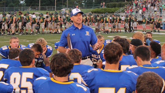 Bolivar High School football coach Lance Roweton (standing) announced he will step aside from coaching football after the Liberators won 13 consecutive COC Small championships.