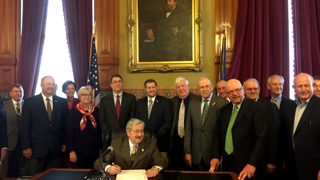 Gov. Terry Branstad talked with reporters Thursday after signing three bills in his formal office at the Iowa Capitol. This group was observing the signing of a bill regarding the establishment of rural improvement zones. He also signed bills to establish an address confidentiality program in the Iowa Secretary of State’s office for victims of domestic violence and certain other crimes, and a measure defining occasional work under the state’s child labor law.