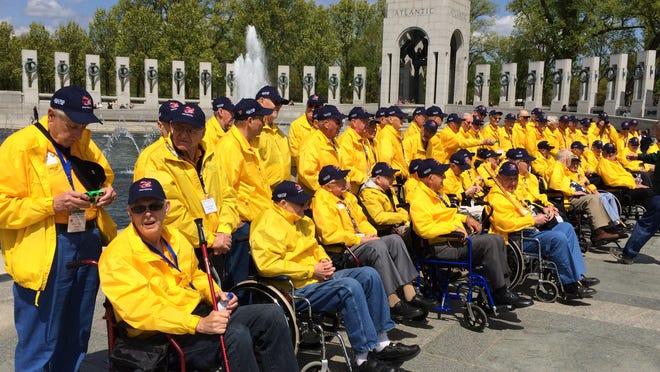 The 80 veterans on the Never Forgotten Honor Flight gather for a group photo at the World War II Memorial in Washington, D.C., during a May 7 Never Forgotten Honor Flight.