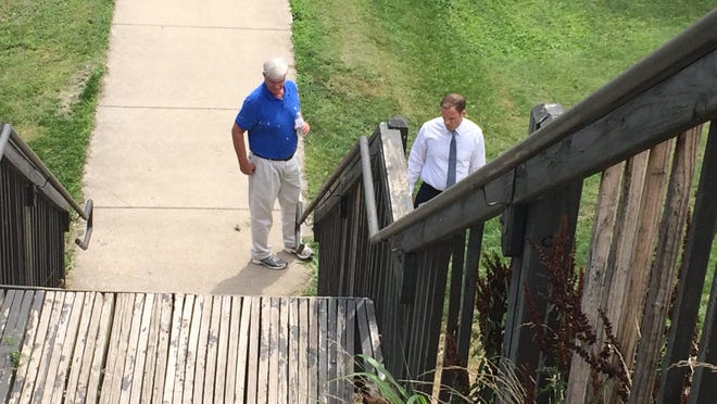 Parks and Recreation Dave Tener, left, and City Auditor Luke Feeney examine the floodwall steps in June.