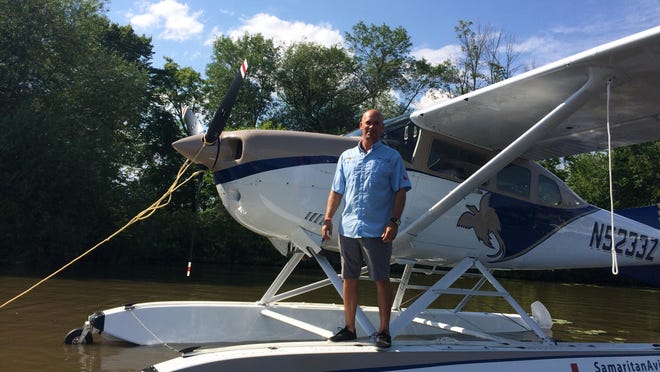 Mark Palm, of Samaritan Aviation, stands on the organization’s newly purchased seaplane that will be used to ship medicine and ferry the sick and injured to Papua New Guinea’s sole hospital.