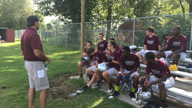 Sacred Heart head football coach Michael Ashlock talks to his team after a water break at practice Friday afternoon.