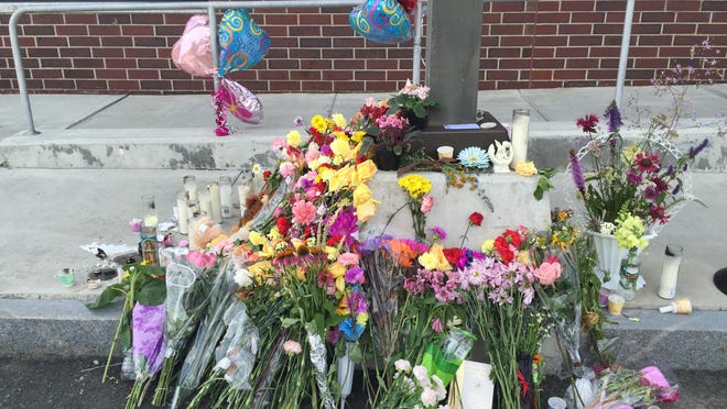 A memorial for social worker Lara Sobel is seen in the days following her killing outside the Department for Children and Families in Barre.