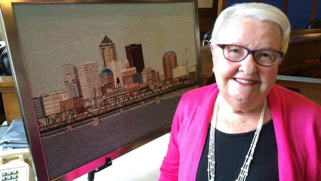 Ankeny artist Joyce O’Brien used thousands of pieces of colorful Persian wool to create a fiber painting of the Des Moines skyline that she donated to hang at Des Moines City Hall.