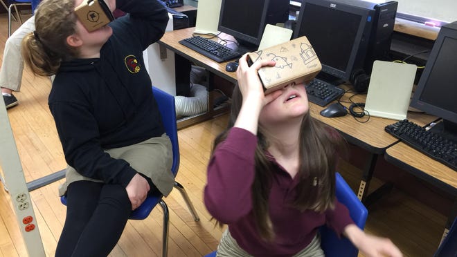 Christ the King seventh-graders Isabelle DiPalermo of Burlington and Deanna Dowhan of St. Albans explore Jerusalem’s Western Wall with the Google Expeditions Pioneer Program.
