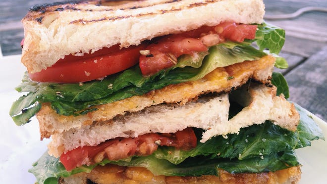 This April 17, 2016 photo shows two favorite sandwiches, the BLT and the grilled cheese, coming together as one, in New Milford, Conn. The buttery crunch of the bread, the juicy tomatoes, the melty cheese, the crisp bacon and lettuce, these two sandwiches were meant to find each other and become one. (AP Photo/Katie Workman)