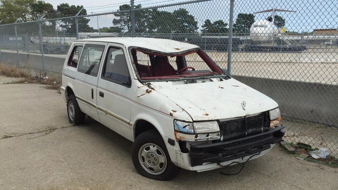 This Aug. 18, 2016 photo provided by the Port Authority shows a van damaged in the Sept. 11, 2001 terrorist attacks on the World Trade Center, outside Hangar 17 at the JFK airport in New York. When the Port Authority shuttered the artifact program in August, officials moved the only remaining artifact to the tarmac. (Amy Passiak/Port Authority of New York and New Jersey via AP)
