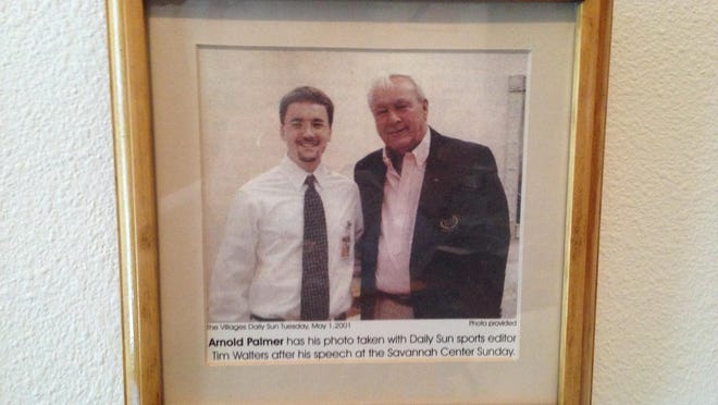 A framed photo hangs in the office of FLORIDA TODAY Sports Editor Tim Walters, commemorating the time her met Arnold Palmer in 2001.