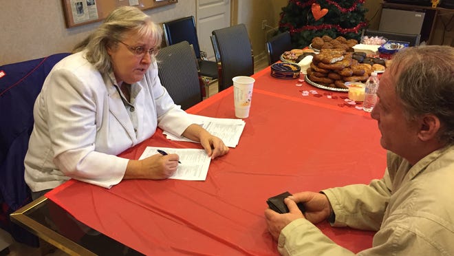 Connie Fahim, a grant writer for the community action agency OCEAN Inc., gives the Point-in-Time survey at Ocean County Hunger Relief to Robert Smolens, a former Toms River resident who has been homeless since he got out of jail last month.