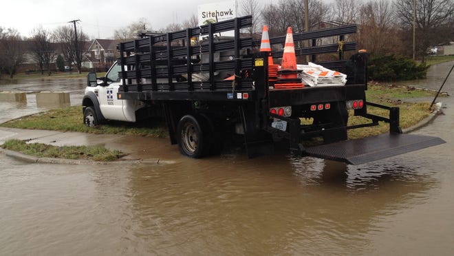 
A Department of Public Works truck sits in standing water on the city’s north side just south of 86th Street and Ditch Road, Thursday, April 3, 2014.
