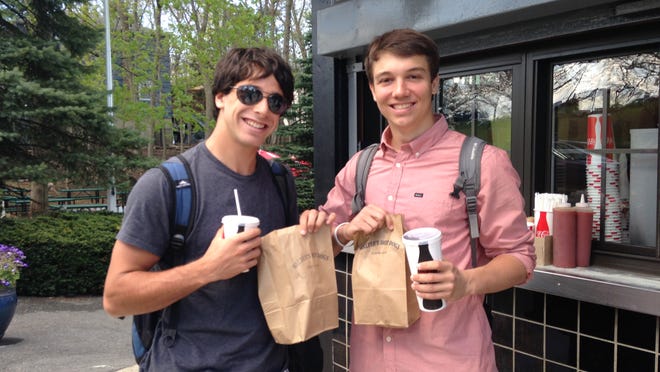 
Alex Biener, left, and Max Ellis, both seniors at Mamaroneck High School, were the first two customers when Walter’s Hot Dogs in Mamaroneck reopened at 10:30 a.m. May 2 after months of renovations.
