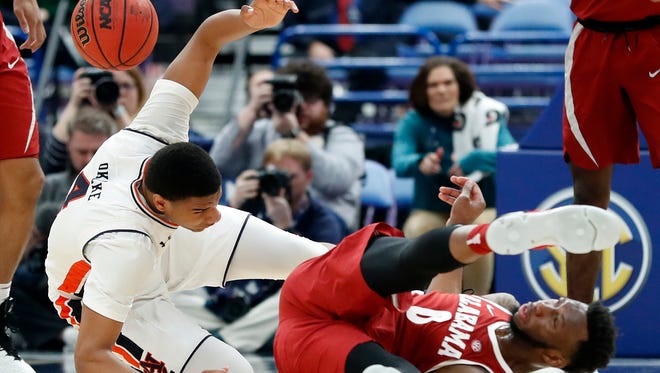 Alabama's Donta Hall, right, flips over Auburn's Chuma Okeke during the second half in an NCAA college basketball quarterfinal game at the Southeastern Conference tournament Friday, March 9, 2018, in St. Louis. Alabama won 81-63. (AP Photo/Jeff Roberson)