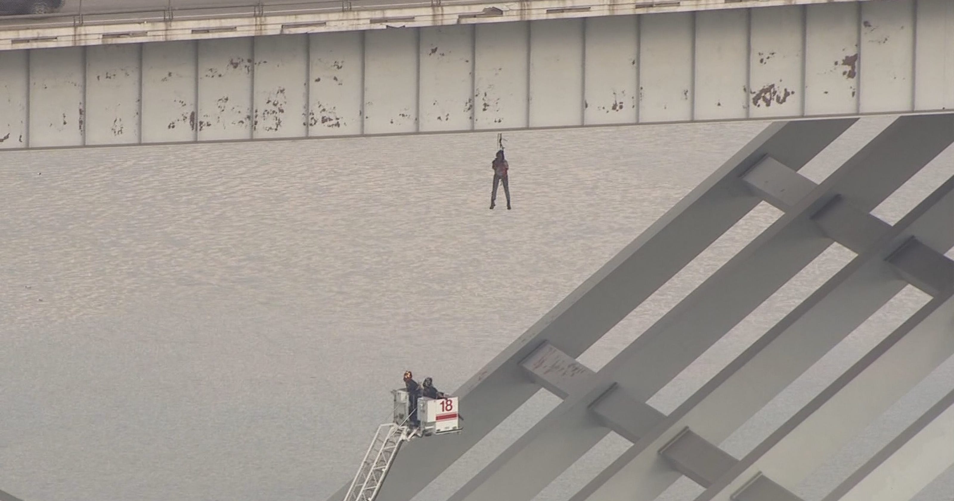 Man dangling off bridge rescued in Houston