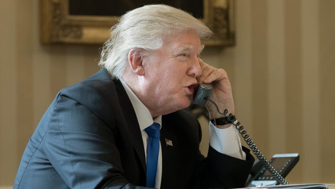President Trump speaks on the phone with President of Russia Vladimir Putin, in the Oval Office of the White House in Washington, D.C. on Jan. 28, 2017.