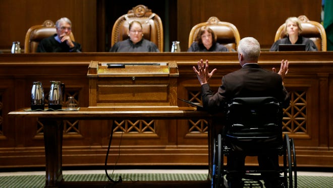 Tom Ahearne, lower right, the lead attorney in a lawsuit against the state of Washington regarding the funding of education, speaks to the state Supreme Court  in Olympia in October. The Washington Supreme Court says lawmakers have successfully finalized a long-running case on state funding of basic education.