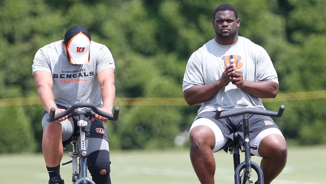 The Bengals' Geno Atkins, right, works out on an exercise bike during practice at Paul Brown Stadium on July 31.