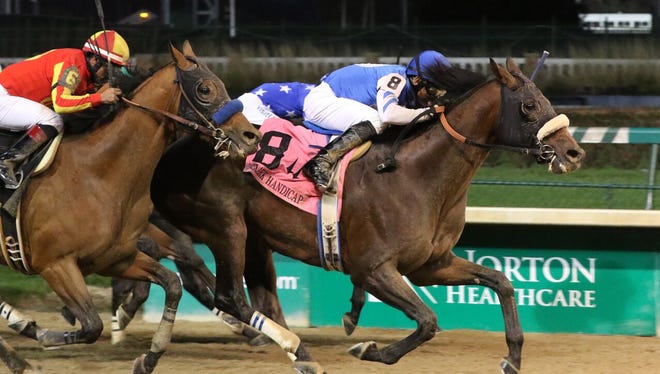 Breeders' Cup Classic runner-up Effinex barreling through the finish line Friday at Churchill Downs.
