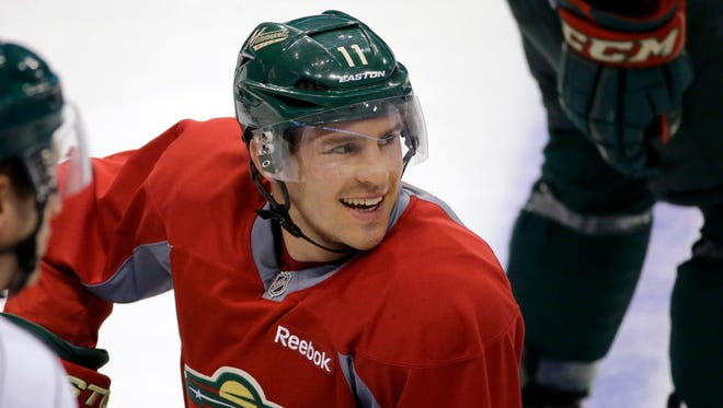 Minnesota Wild left wing Zach Parise smiles at a teammate during NHL hockey training camp in St. Paul on Friday.