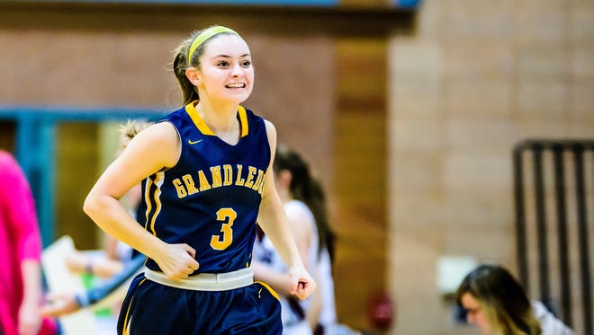 Mackenzie Todd of Grand Ledge celebrates as she runs back to the bench in a timeout after Grand Ledge took a 27-15 lead over Okemos in the 3rd quarter of their game Friday February 3, 2017 in Okemos.
