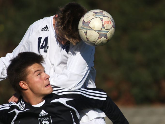 Brookfield East's Erik Solie (14) heads the ball away
