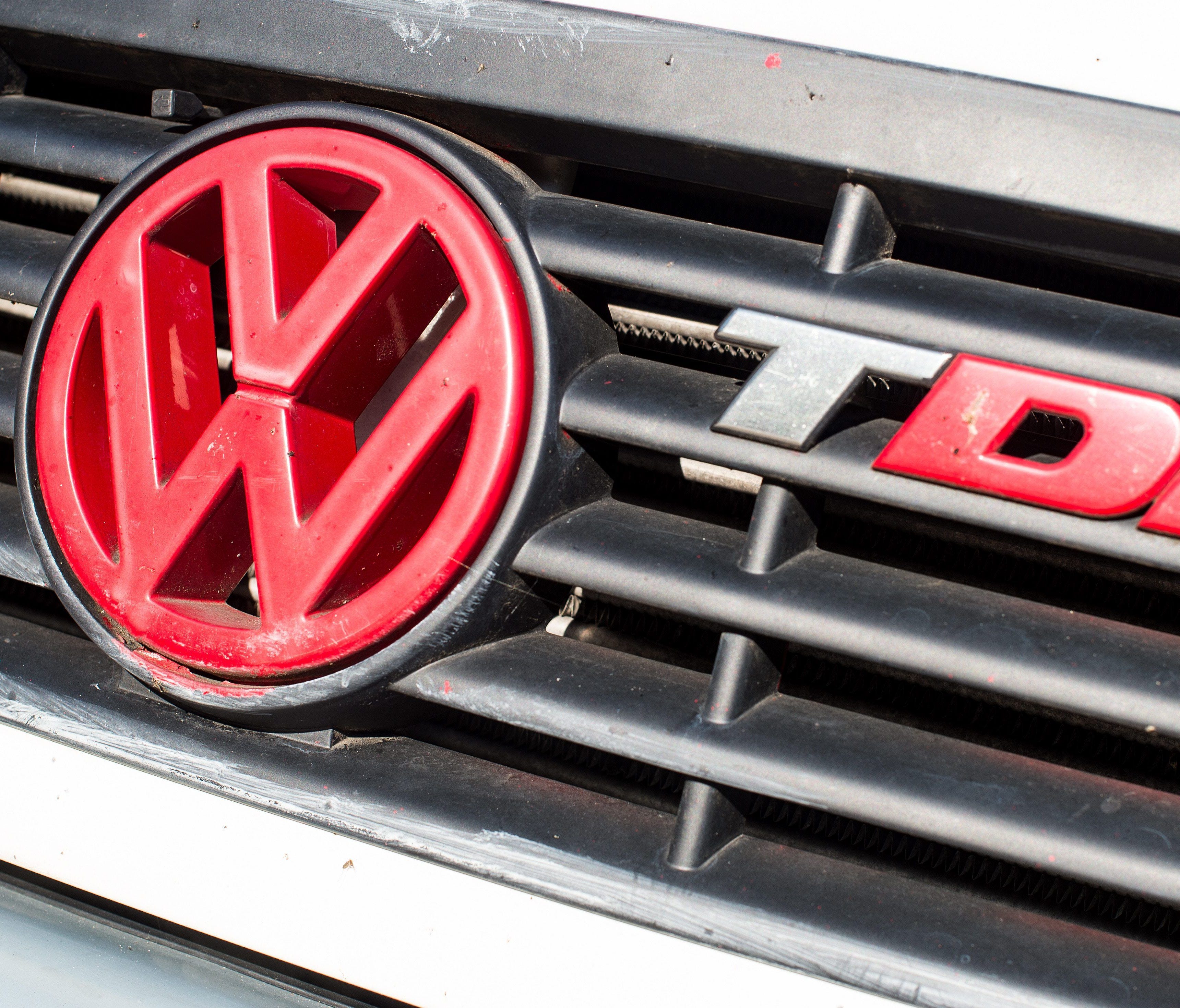 A red Volkswagen logo on a diesel-powered vehicle next to the abbreviation TDI (Turbocharged direct injection) in Frankfurt