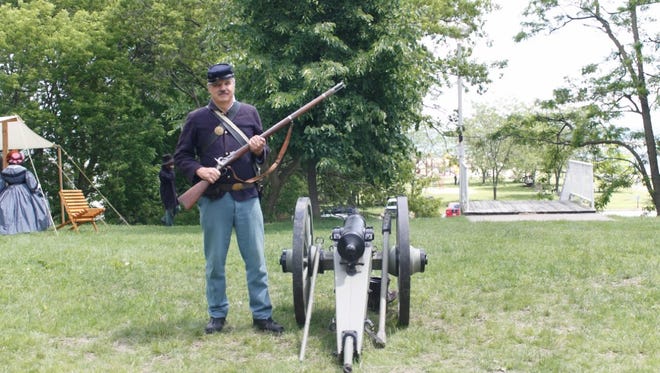 Michael Ruffini poses with a working cannon in the Union camp Sunday in Lexington. After helping to organize the event for 10 years, he returned from Florida to reenact this year.