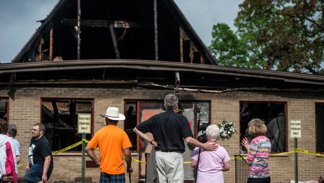 Robert Foote, a circuit counselor within the Lutheran Church, comforts church member Peg Lindstrom, 72, of Vestal, after a fire gutted the Grace Lutheran Church in Vestal early Tuesday morning.
