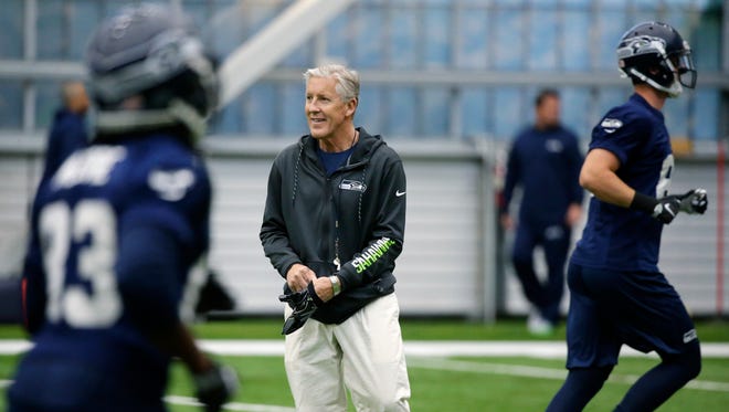 Seattle Seahawks head coach Pete Carroll watches drills during the team's NFL football rookie minicamp in Seattle.