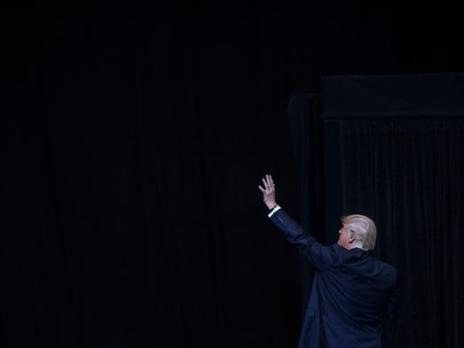 President Donald Trump waves goodbye to the crowd as