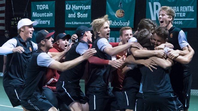 The USC men's tennis team celebrates after beating UCLA 4-3 to win the Pac-12 title at The Ojai Tennis Tournament on Saturday night.