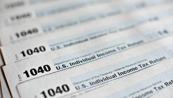 U.S. Department of the Treasury Internal Revenue Service (IRS) 1040 Individual Income Tax forms for the 2014 tax year are arranged for a photograph in Tiskilwa, Illinois, U.S., on Monday, March 16, 2015.
