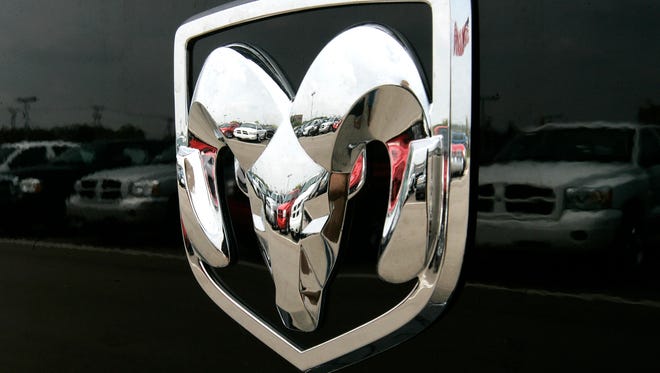 FILE - This Thursday, July 27, 2006, file photo, shows the Dodge logo on a Ram pickup truck at a dealership in Bloomfield Hills, Mich. Fiat Chrysler is recalling about 67,000 model year 2006 and 2007 pickups because of a problem that could prevent the cars from starting, or cause them to move when the ignition key is turned. The company is recalling Dodge Dakota, Dodge Ram 1500, 2500, 3500 and Mitsubishi Raider pickups that were made between July 2005 and June 2006. Nearly 55,000 of them are in the U.S. (AP Photo/Paul Sancya, File)