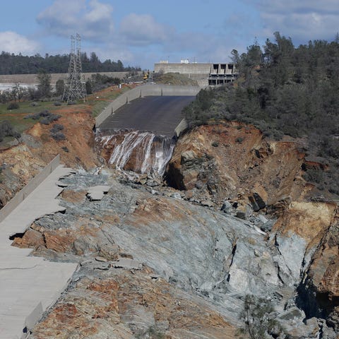 A small flow of water drops down Oroville Dam's cr