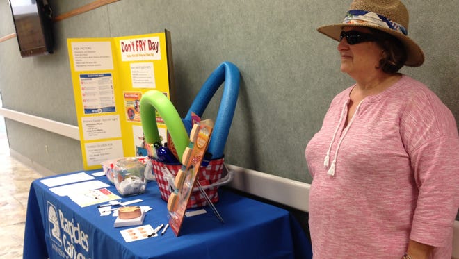 Ann Vanderlick stands in the main hallway at Rapides Regional Medical Center Friday to raise awareness about the dangers of skin cancer and sun exposure.